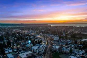 This is another captivating aerial image, with the city lights transitioning into nature and perfectly framing the property within the larger Seattle area.