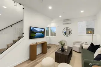 Catch up on your favorite shows or unwind after a long day in this cozy yet stylish living area, enhanced by oversized windows that frame the surrounding greenery.