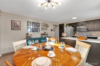 Dining area off of the kitchen with trendy lighting.