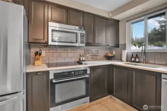 Kitchen overlooks private backyard.