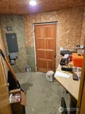 Indoor workroom with a door to the outside.