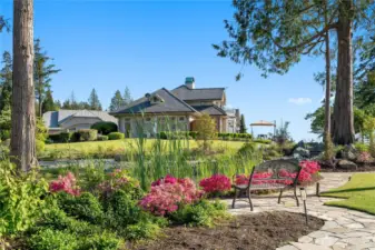 Mature trees and seasonal blooms  adorn the Rose garden and over 5 acres of land to the North. This beautiful luxury ,serenity, habitat pond with gentle terraced waterfall echoes with life in the evening.
