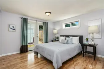 Primary bedroom with a walk-in closet, bathroom, and french doors to outside.