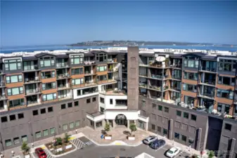 Welcome to the Rainier—Ruston's landmark building.  This isn’t just a condo. This is a lifestyle anchored by sleek design, access to trails and restaurants, and the kind of daily views you don’t grow tired of. With secured entry, private parking, and immediate proximity to the waterfront and Point Ruston shops, this building is an ideal launchpad for modern Pacific Northwest living.