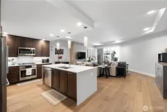 Effortless flow from kitchen to comfort.  This open-concept design brings your kitchen, dining, and living spaces together in a layout that feels both expansive and intentional. Whether you're hosting game night or enjoying a quiet evening with the fireplace glowing, this condo adapts to your lifestyle—refined, functional, and ready for anything.