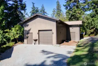 Expansive 2-bay shop with dual driveways, huge ceilings and loads of space for all your hobbies, tools, toys, and storage needs.