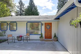 Cute patio area with various flowers & shrubs to enjoy spring through fall!