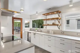 Wolf wall ovens, Fisher & Paykel two drawer dishwasher, Liebherr refrigerator, and induction cooktop.