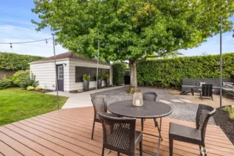 Just to the left of the patio set is a platform made to fit a cantilever umbrella so as not to take up deck space.