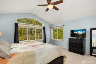 Primary bedroom with vaulted ceiling