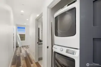 Washer/dryer located conveniently next to primary bed and bath on upper floor.