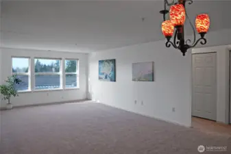 Spacious Living and Dining area with Fireplace and Large Windows to let in the Natural Light.