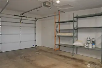 Spacious one car garage with a bench and storgage.