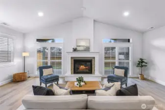 Gas fireplace is flanked by 2 siding door to access covered patio