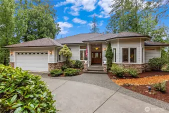 Front exterior with attached garage, driveway, and your low-maintenance yard.