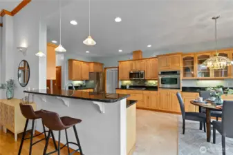 Kitchen with peninsula seating, ample cabinetry, and open layout