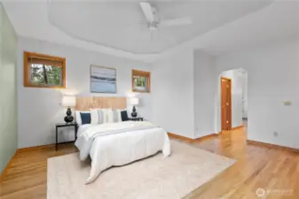 Generous primary bedroom with ensuite bath, walk-in closet and back deck access.