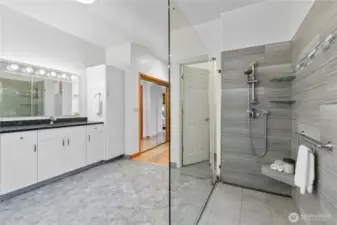 Primary bathroom with double vanity, overhead lighting, and storage cabinetry.