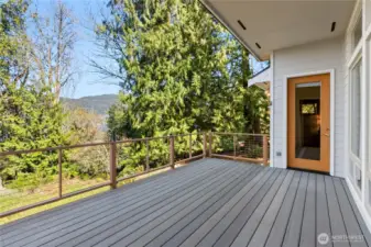 Covered deck with railing and access door from the primary suite.