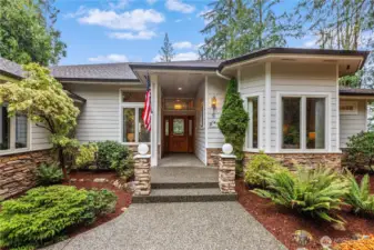 The attractive exterior is loaded with curb appeal thanks to a covered entry and mature landscaping