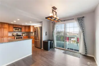 Additional view of the dining area and kitchen.