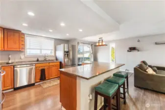 Spacious kitchen with granite counters, stainless appliances, breakfast bar and plenty of cabinet and counter space.