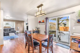 The generous dining area flows effortlessly into the family room, kitchen, and out to the fenced backyard with a partially covered deck.