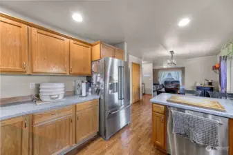 This view of the kitchen highlights open concept connecting to the dining room and family room.