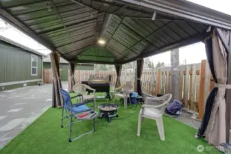 Great fully fenced low maintenance yard with patio pavers, gazebo, firepit, barbeque area.