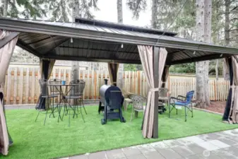 Great fully fenced low maintenance yard with patio pavers, gazebo, firepit, barbeque area.