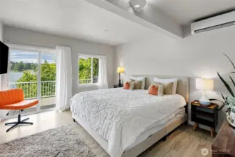 The primary bedroom is a private haven located on the main floor for easy access. Wake to serene lake views, step onto the deck from your own entrance, and enjoy the oversized walk-in closet—perfect as-is or ready to be reimagined as a sitting room or second kitchen for multi-generational living.