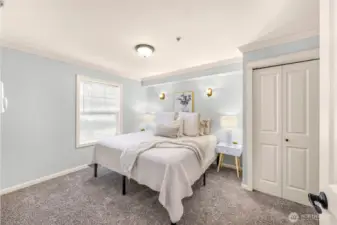 King size bed highlights the spacious and bright primary bedroom