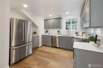 This fully updated kitchen offers beautiful cabinetry, quartz countertops, and brand new stainless steel appliances.