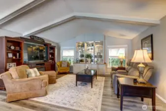 Walk into the Entry that opens to the Living Room enhanced with Vaulted Ceilings & Built-In Entertainment Center!