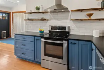 Custom shelves and subway tile infuse the kitchen with a fresh, curated feel.