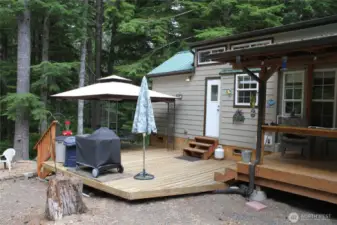 Lower deck with open area for sun and a gazebo area to keep cool