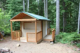 New 10 x 16 shed with porch and bar.