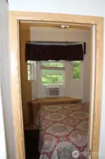 As you enter the bedroom, air conditioning in the window.