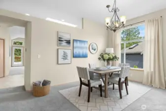 Elegant dining area with room for large gatherings and easy access to the deck for outdoor entertaining.(Virtually Staged)