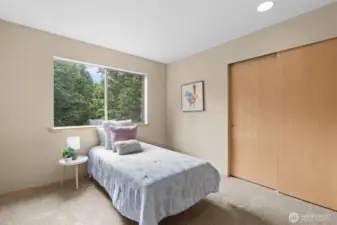 Bed#2. A cozy and well-lit second bedroom, ideal for a child's room or guest space, complete with ample closet storage.