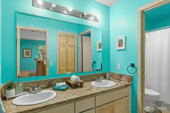 A well-appointed full bath serves the downstairs bedrooms, offering clean, contemporary design and easy functionality.(Virtually Staged)