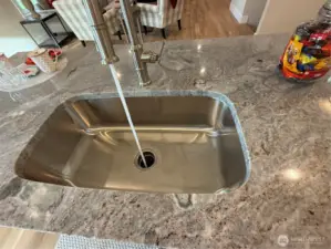 Under mounted stainless steel sink with Gerber Kinzie single pull faucet