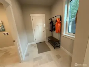 Mud room with door leading to large over sized garage