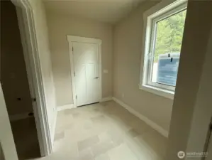 Mud room accessed from garage and coat closet