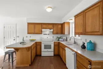 With plenty of cabinetry storage and extra breakfast bar space, this kitchen blends simplicity with productivity.
