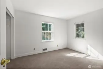 Beyond the main living areas lies a bright, airy secondary bedroom waiting for your personal touch.