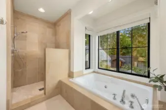 Second ensuite bathroom on second floor with deep tub and large shower.