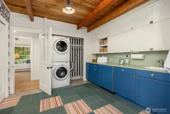 Fantastic mud/laundry room! This is the space every home needs.... Custom cabinetry and sink, under-counter Sub-Zero beverage fridge and a wall of closet space.