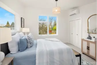 Teh primary bedoom.  Looking south through the oversized windows and a view of the small closet.