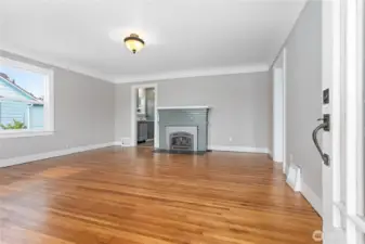 Living room features gas fireplace and refinished wood floors
